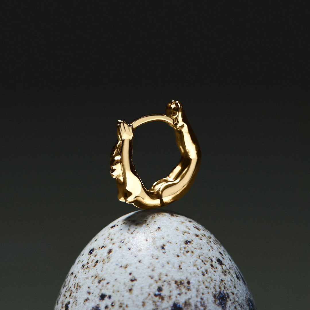 Female body piercing in 18k gold