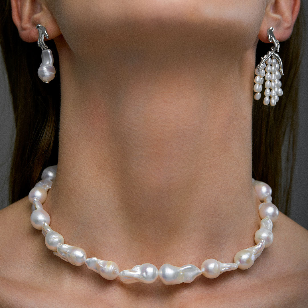 Model wearing baroque pearl necklace and sterling silver earrings