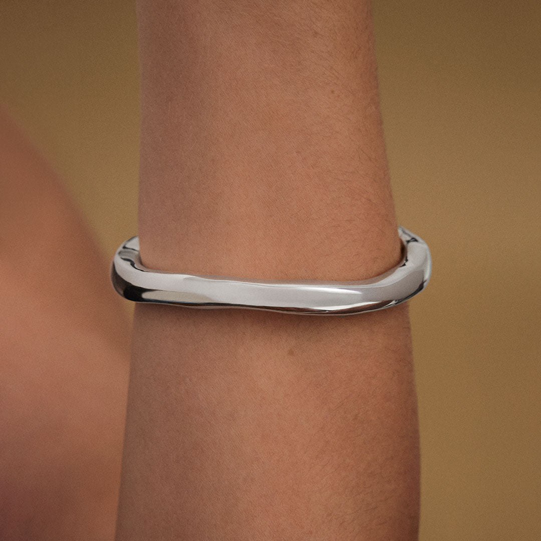 Model wearing abstract bracelet in sterling silver