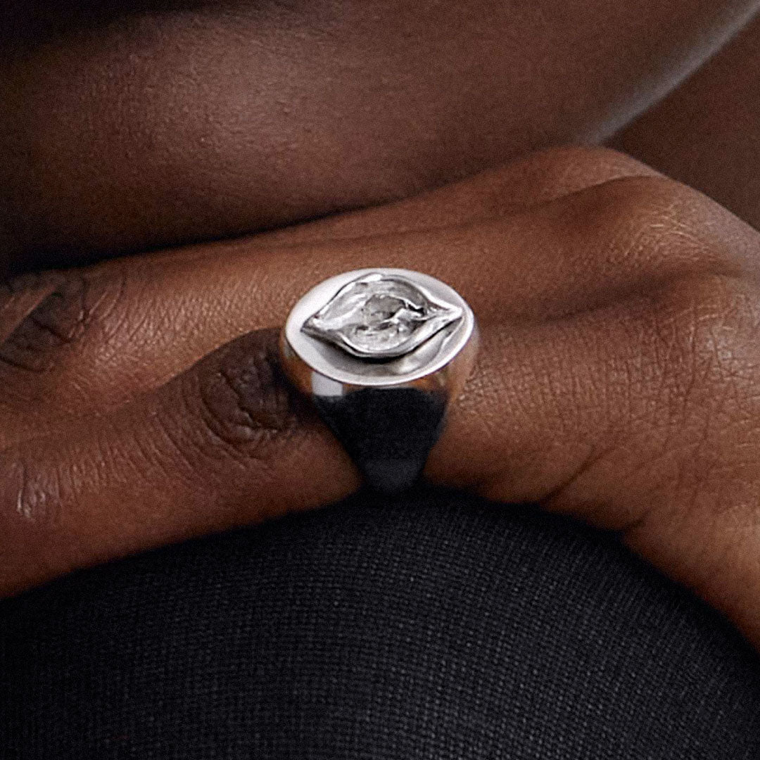 Model wearing a chevalier ring of a vulva in sterling silver