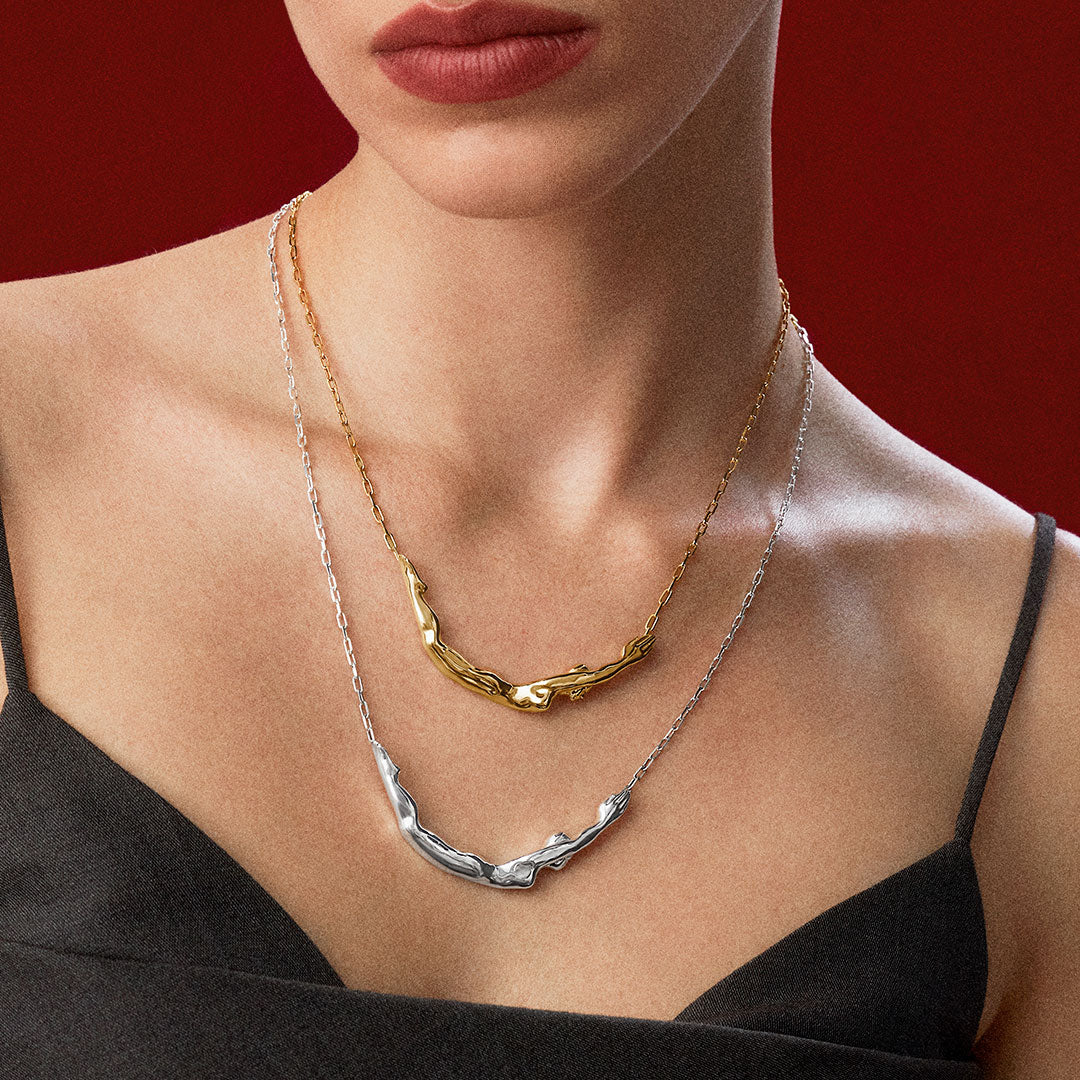 Model wearing sterling silver necklaces with 18k gold plating of female bodies