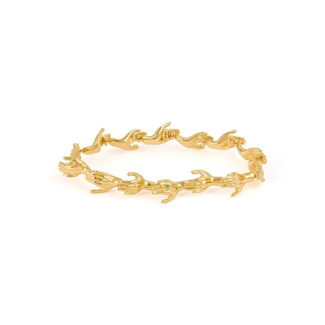 Paola Vilas bracelet in sterling silver with 18k gold plating featuring hand shapes in a chain adorned with emerald
