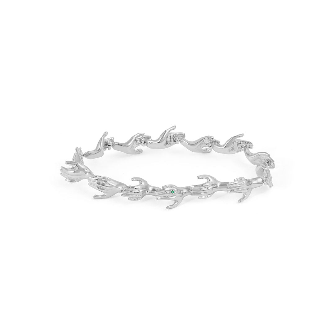 Paola Vilas bracelet in sterling silver featuring hand shapes in a chain adorned with emerald