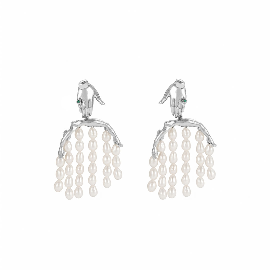 Paola Vilas earring in sterling silver featuring a hand and body with pearl strands