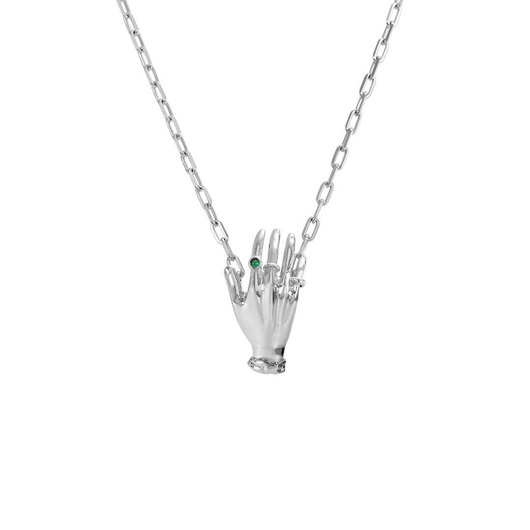 Paola Vilas necklace in sterling silver featuring a hand adorned with emerald