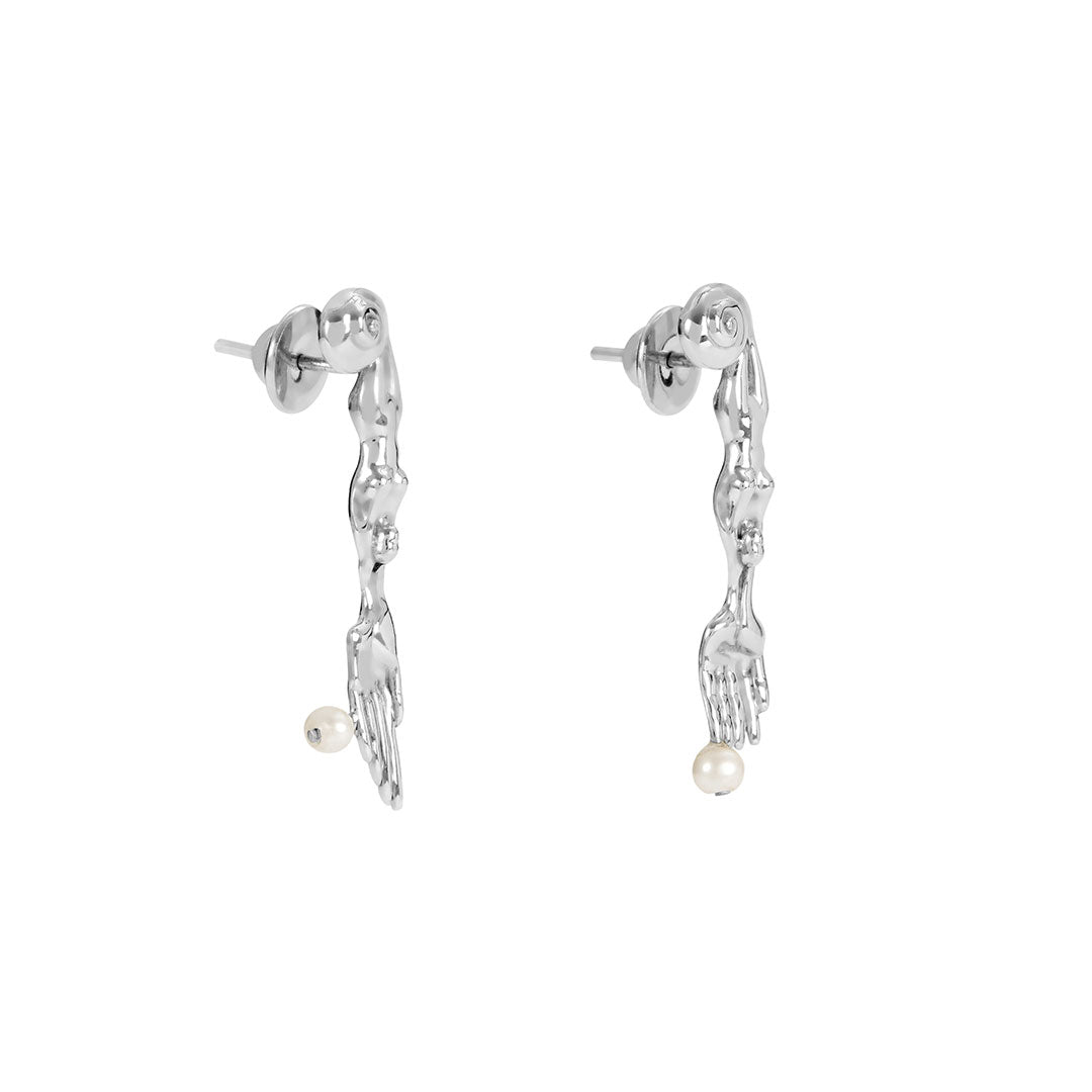 Paola Vilas earring in sterling silver featuring mini surrealist fork and knife with natural pearls