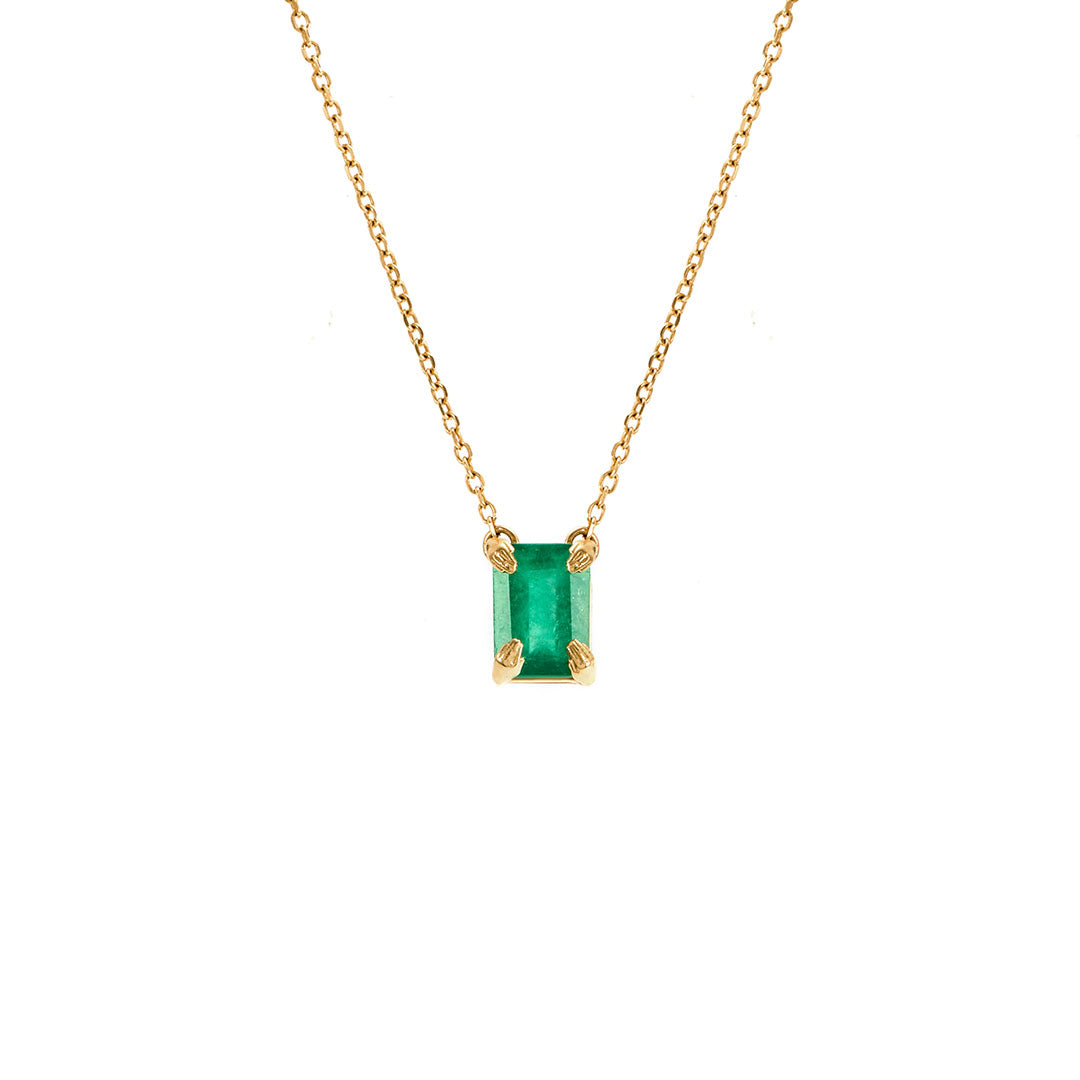 Paola Vilas 18k gold necklace with sculpted hands holding an emerald