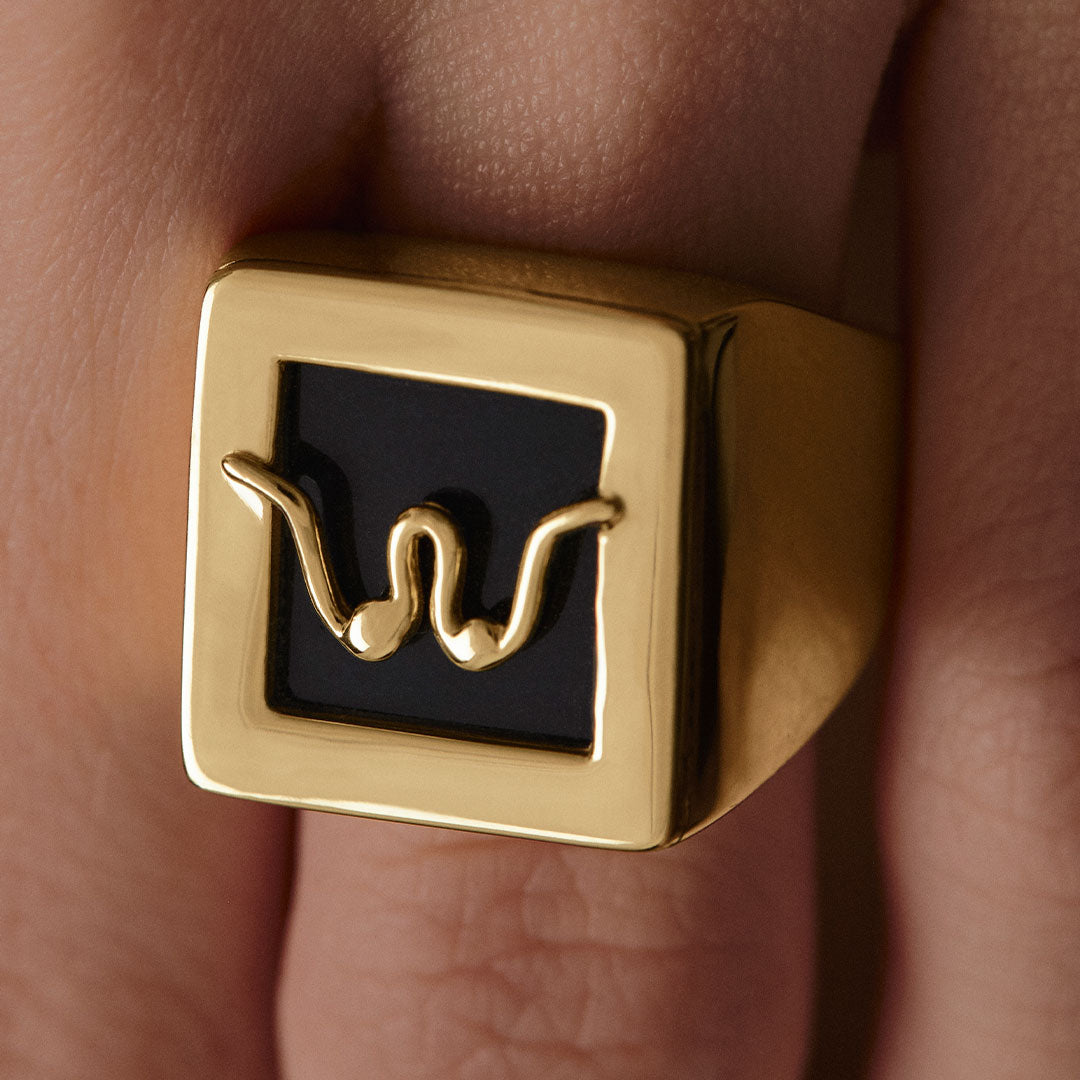 Model wearing Paola Vilas chevalier ring in sterling silver with 18k gold plating featuring an abstract breasts
