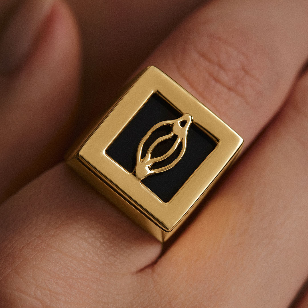 Model wearing Paola Vilas chevalier ring in sterling silver with 18k gold plating featuring an abstract vulva