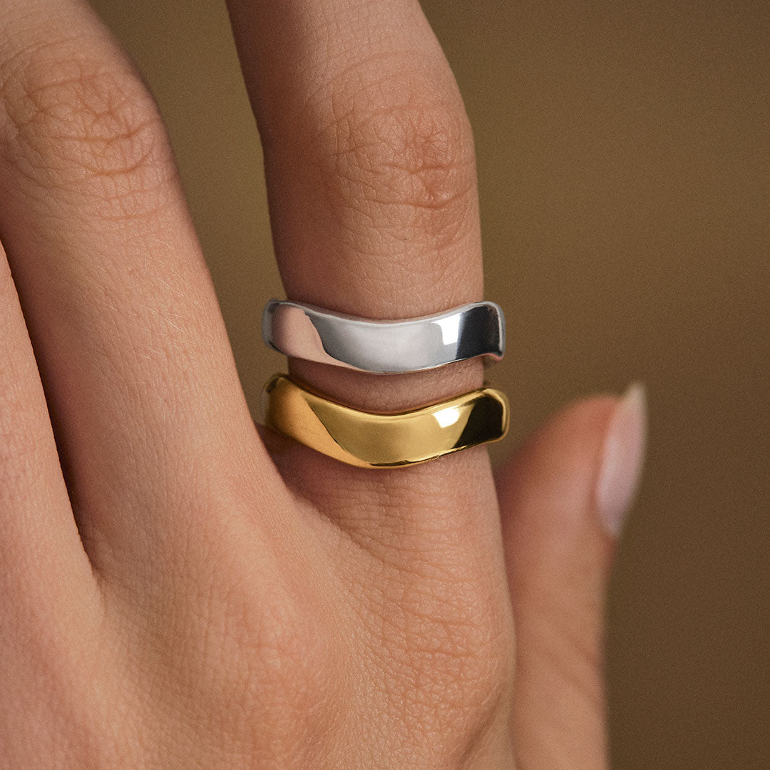 Model wearing organically shaped rings in sterling silver with 18k gold plating