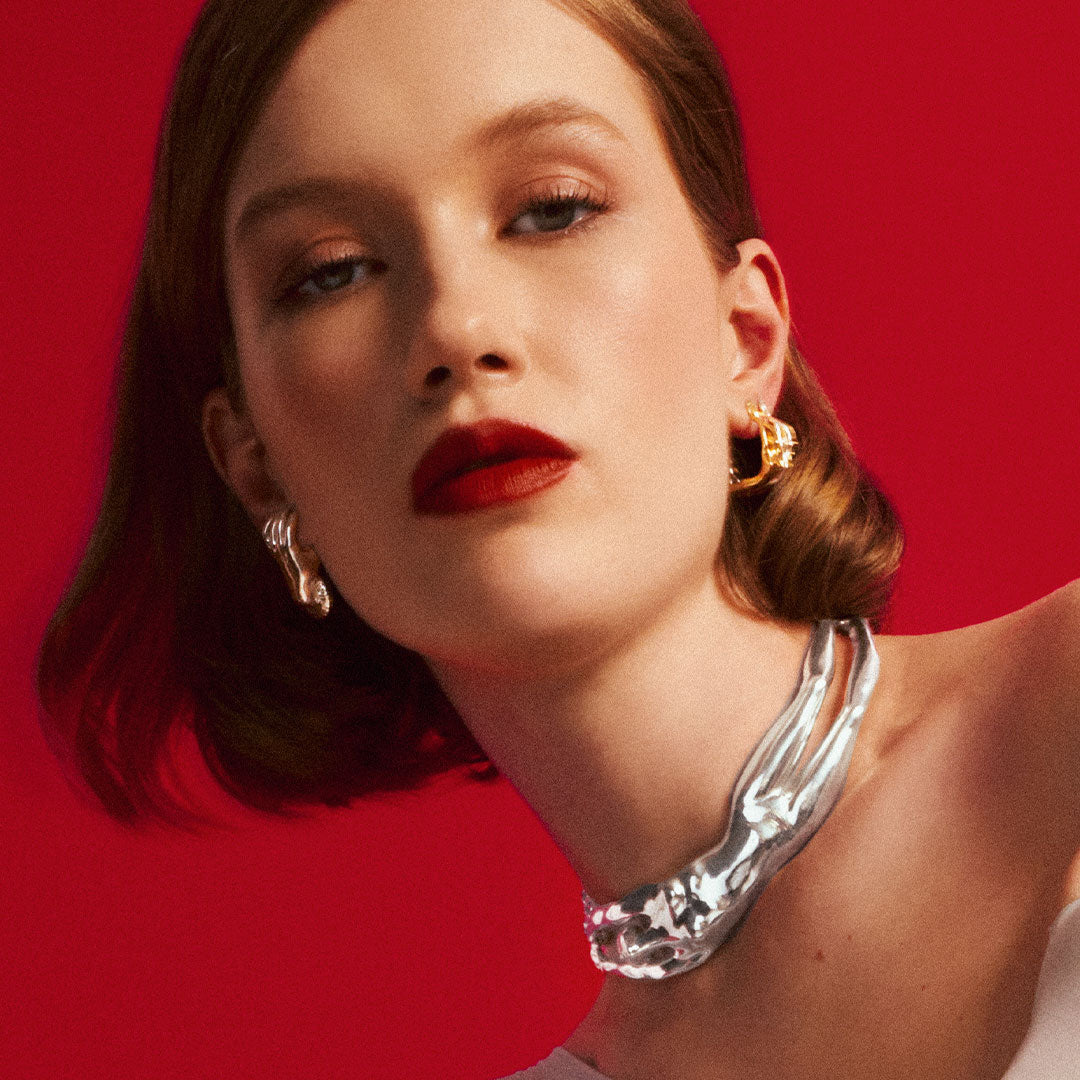 Model wearing a sterling silver necklace of a female body