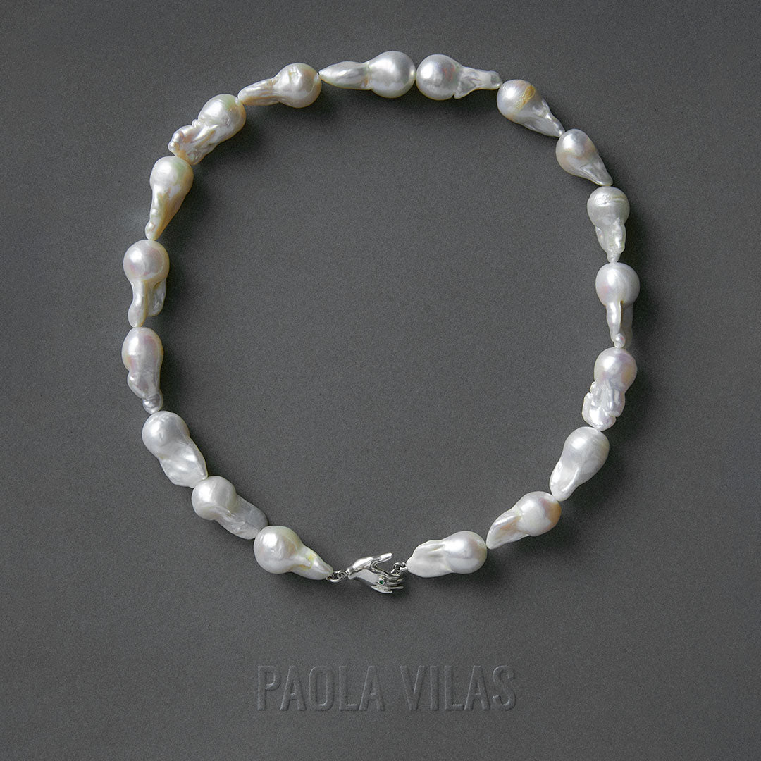 Baroque pearl necklace with sterling silver hand detail adorned with emerald