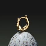 Female body piercing in 18k gold