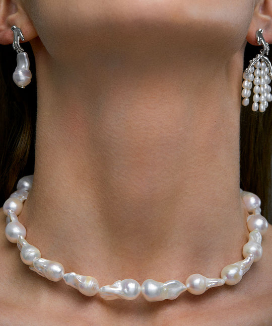 Model wearing baroque pearl necklace and sterling silver earrings
