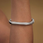 Model wearing abstract bracelet in sterling silver