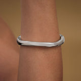 Model wearing abstract bracelet in sterling silver