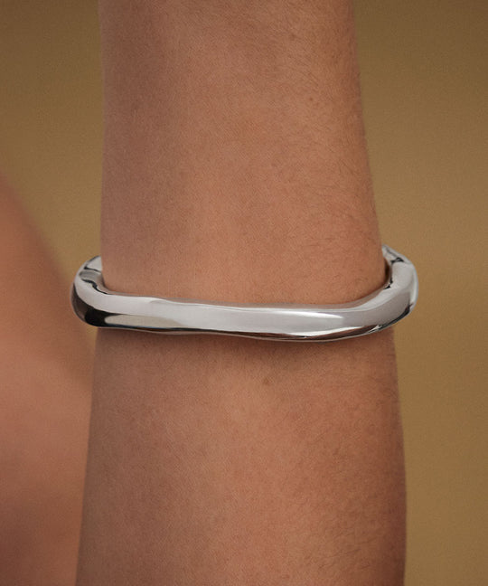 Model wearing abstract bracelet in sterling silver