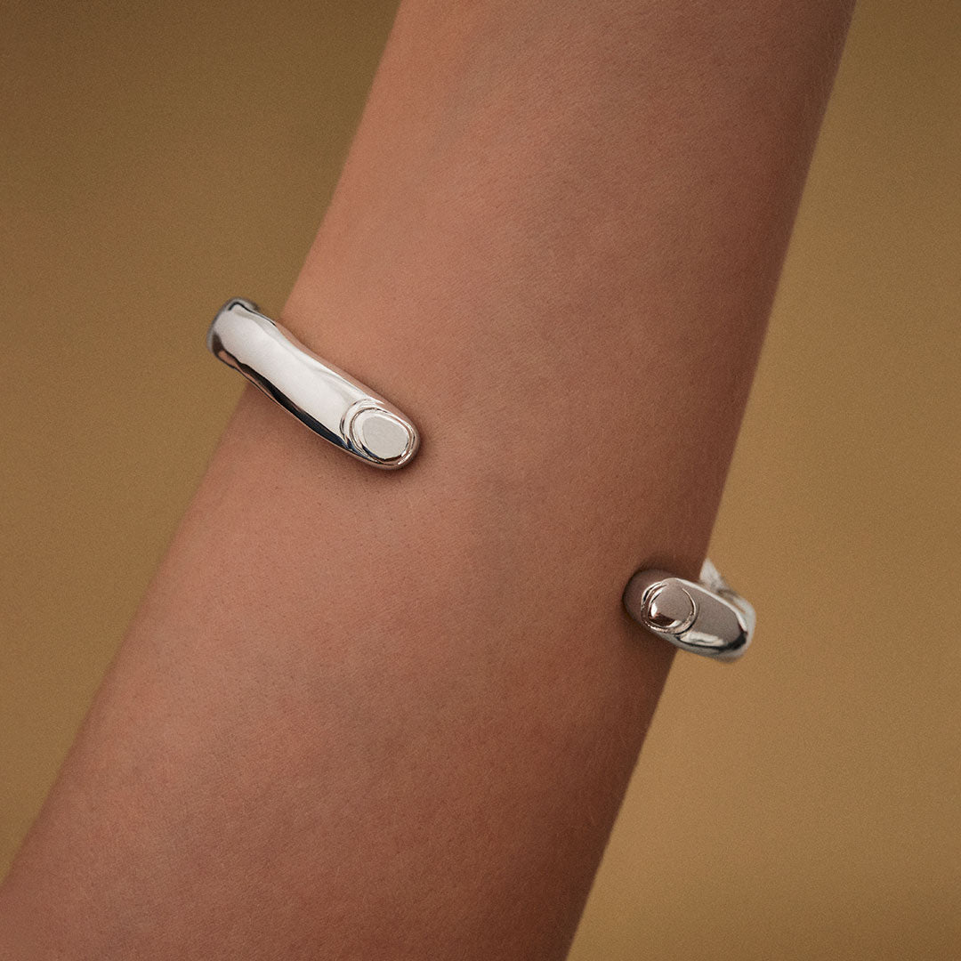 Model wearing surrealist finger bracelet in sterling silver
