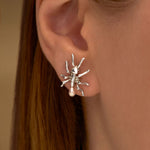 Model wearing ant earring in sterling silver with pearls