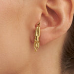 Model wearing earring of a woman's body in 925 silver with 18k gold plating
