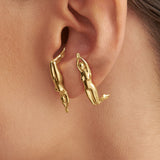 Model wearing earrings in 925 silver with 18k gold plating of a woman's body
