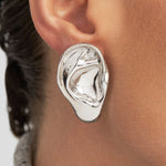 Model wearing sculpted ear earring in sterling silver