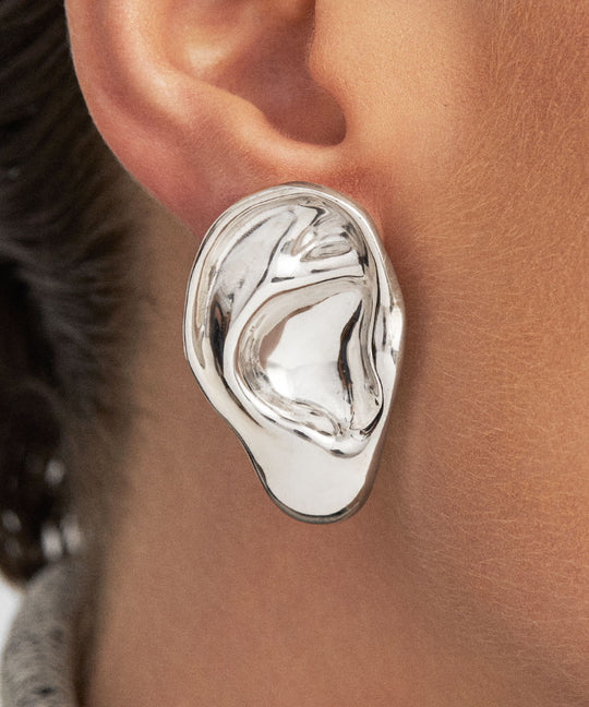 Model wearing sculpted ear earring in sterling silver