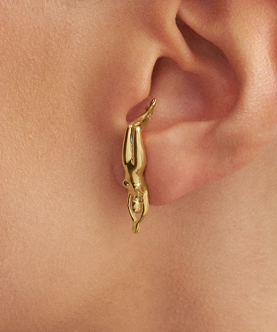 Model wearing earring in 925 silver with 18k gold plating of fa woman's body