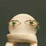 Eye-shaped earrings formed by bodies in 18k gold and emeralds