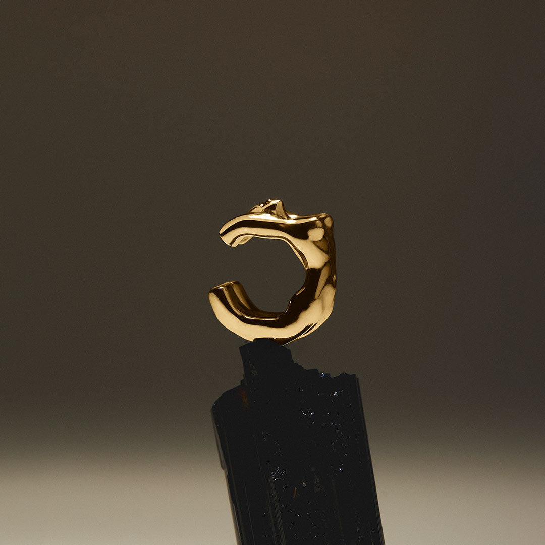 Female body earcuff in sterling silver with 18k gold plating