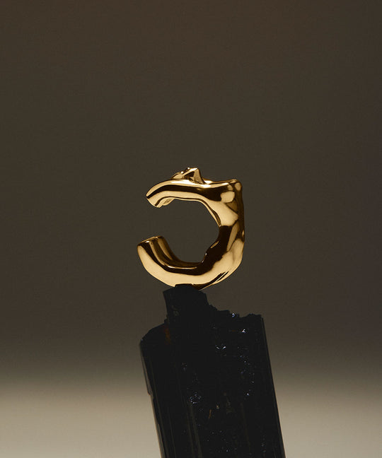 Female body earcuff in sterling silver with 18k gold plating