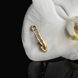 Sterling silver earring with 18k gold plating featuring a safety pin and female body