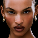 Model wearing a clip-on piercing in sterling silver with 18k gold plating of a female body