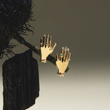 Hand-shaped earrings in sterling silver with 18k gold plating and emeralds