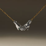 Joined hands necklace in sterling silver with 18k gold-plated chain and emerald