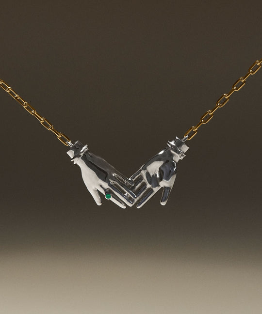 Joined hands necklace in sterling silver with 18k gold-plated chain and emerald