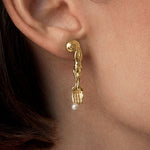Model wearing 18k gold-plated sterling silver earring with natural pearl and mini surrealist fork