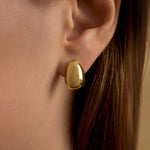 Model wearing egg earring in sterling silver with 18k gold plating