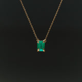 18k gold necklace with rectangular emerald and sculpted hands