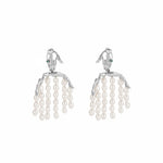 Paola Vilas earring in sterling silver featuring a hand and body with pearl strands