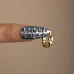 Model wearing Paola Vilas female body piercing in 18k gold