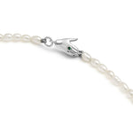 Paola Vilas necklace with hand-shaped clasp in sterling silver adorned with emerald and pearls