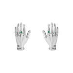 Paola Vilas earrings in sterling silver featuring sculptural hands adorned with emeralds