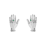 Paola Vilas earrings in sterling silver featuring sculptural hands adorned with emeralds