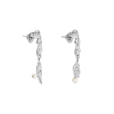 Paola Vilas earring in sterling silver featuring mini surrealist fork and knife with natural pearls