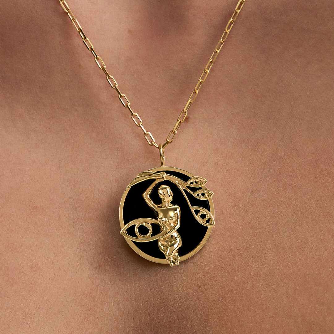 Model wearing Virgo zodiac necklace in sterling silver with 18k gold plating