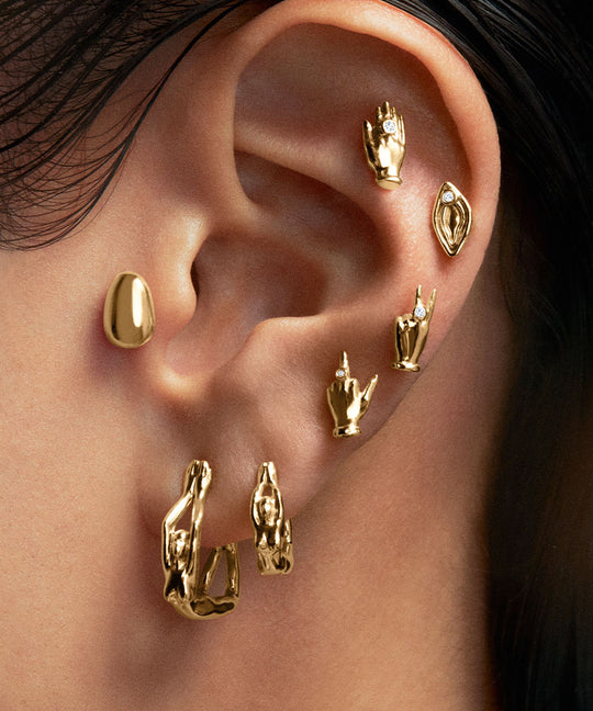 Model wearing 18k gold and diamond piercings
