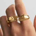 Model wearing sterling silver hand rings with 18k gold plating and emeralds