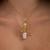 Model wearing large ant pendant on sterling silver chain with 18k gold plating