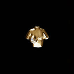 18k gold female bust piercing adorned with a diamond
